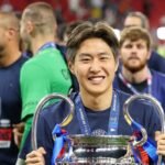 Lee Kang-in of PSG with the UEFA Champions League 2026 champion trophy in Budapest, Hungary. Credit: REUTERS/Andrew Boyers