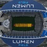 The Lumen Field pitch receives artificial light treatment for World Cup matches. Photo: Steph Chambers / AFP