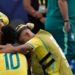 Neymar cried at the end of the match and was comforted by his teammates. Photo: Seth Wenig / AP Photo